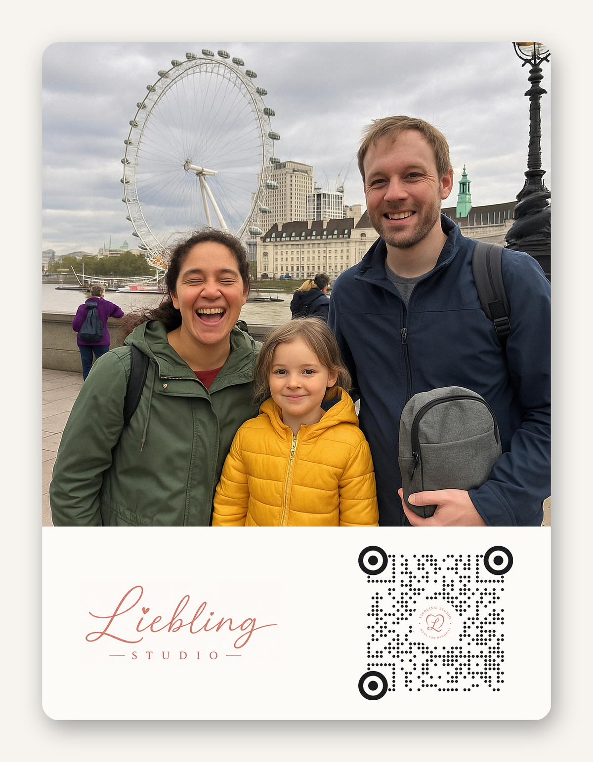 A square photo print featuring a family of three smiling in front of the London Eye, with a white lower section containing the text 'Liebling STUDIO' and a QR code.